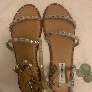 Strappy sandals laced with silver studs